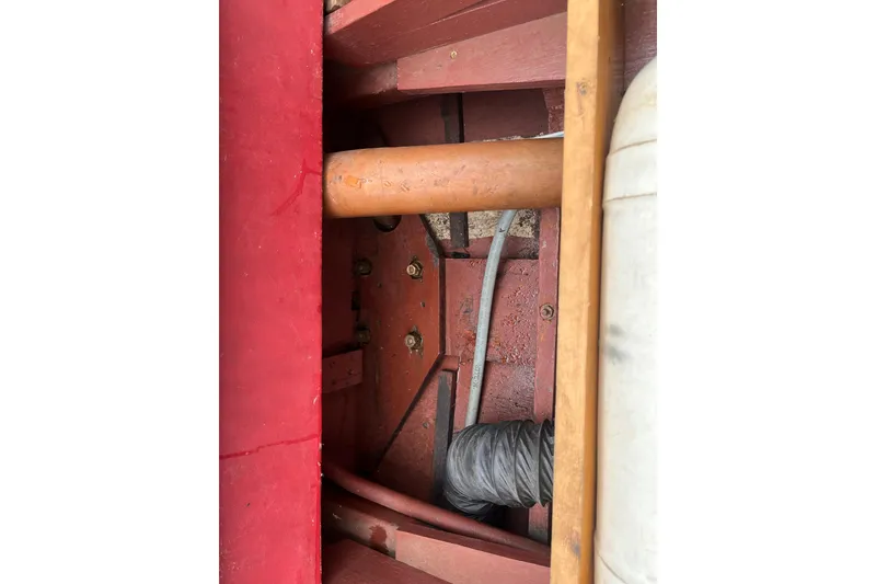 Slide: The Image of Interior view of a 1956 Chris-Craft 17 Sportsman boat, showcasing wooden and metal components. - 13