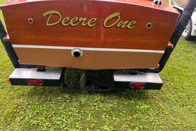 Slide: The Image of 1956 Chris-Craft 17 Sportsman boat with "Deere One" on the stern, parked on grass. - 4