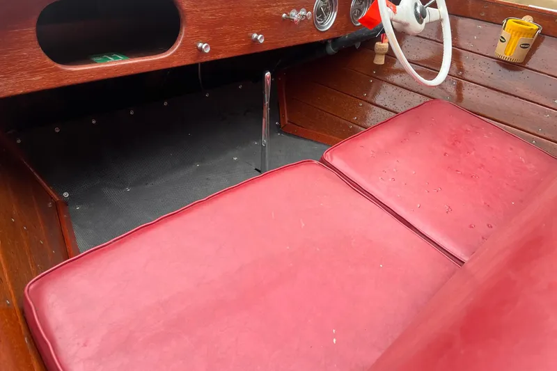 Slide: The Image of Interior of a 1956 Chris-Craft 17 Sportsman boat with red seats and wooden dashboard. - 6