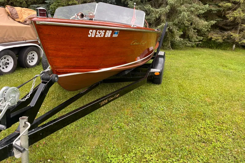 Slide: The Image of 1956 Chris-Craft 17 Sportsman boat on trailer, parked on grass. - 7