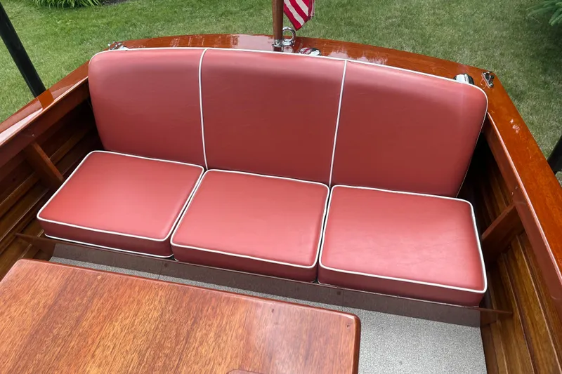 Slide: The Image of 1955 Chris-Craft 17 Sportsman boat with red cushioned seating and wooden interior. - 12