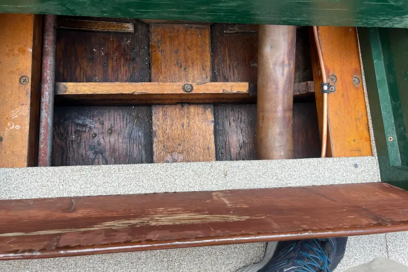 Slide: The Image of Interior view of a 1955 Chris-Craft 17 Sportsman boat, showcasing wooden flooring and structural details. - 16