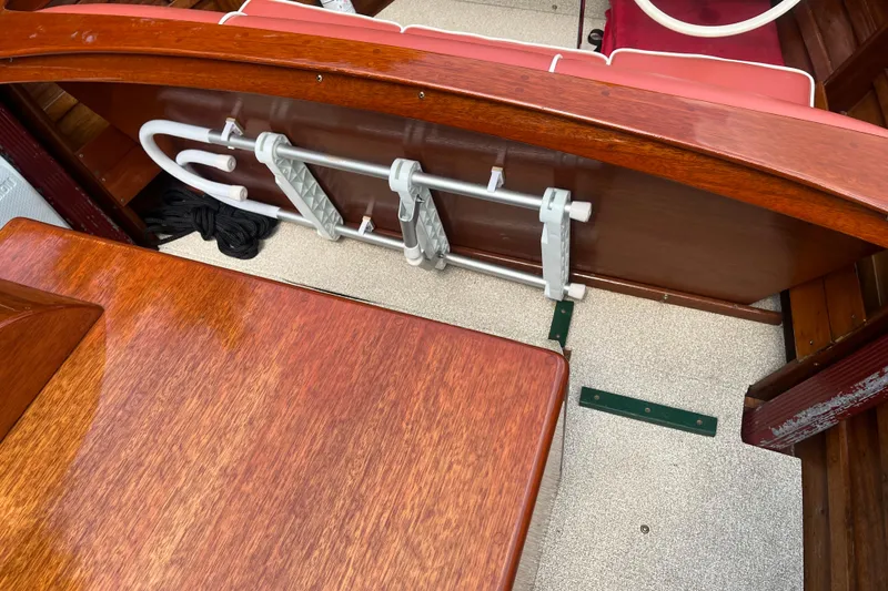 Slide: The Image of 1955 Chris-Craft 17 Sportsman interior with wooden finish and foldable ladder. - 17