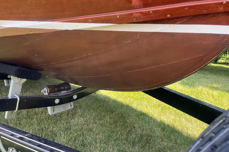 Slide: The Image of 1955 Chris-Craft 17 Sportsman boat on trailer, showcasing wooden hull detail. - 19