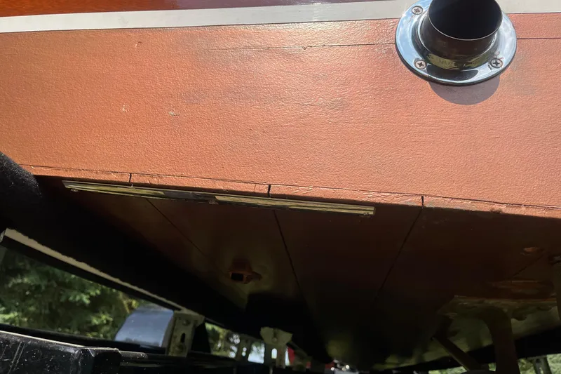 Slide: The Image of 1955 Chris-Craft 17 Sportsman boat underside with visible exhaust pipe detail. - 21