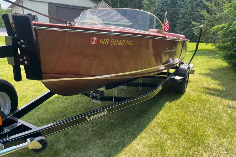 Slide: The Image of 1955 Chris-Craft 17 Sportsman boat on trailer, displayed outdoors on grass. - 5