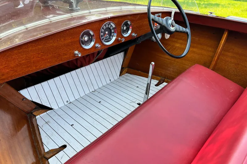 Slide: The Image of 1958 Chris-Craft 16 Cavalier boat interior with red seats and classic dashboard. - 15
