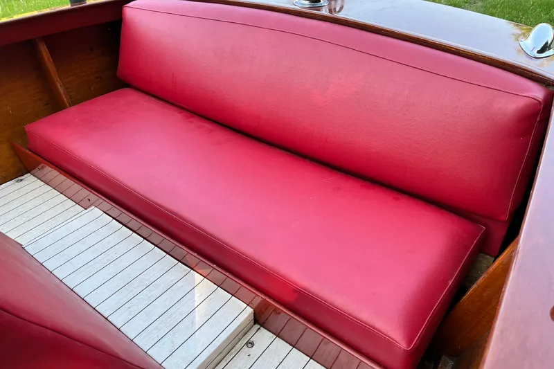 Slide: The Image of Red leather seating in a 1958 Chris-Craft 16 Cavalier boat interior. - 16