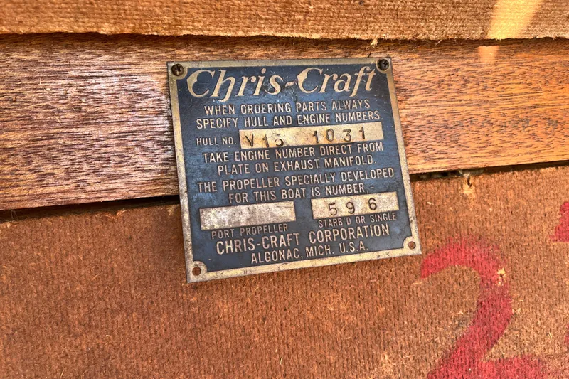 Slide: The Image of 1958 Chris-Craft 16 Cavalier nameplate on wooden surface, displaying hull and engine details. - 7