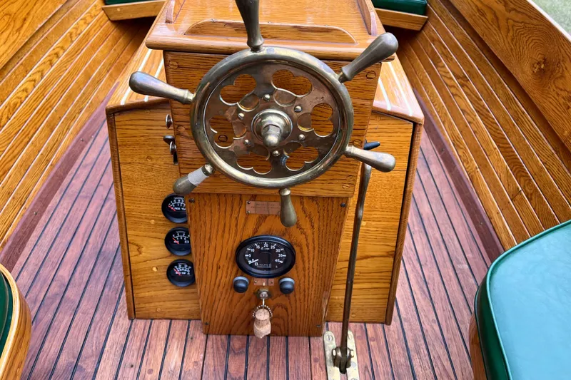 Slide: The Image of Vintage 1908 Outing launch boat steering wheel and dashboard with wooden finish. - 12