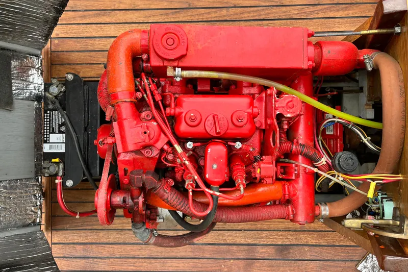 Slide: The Image of Red engine of a 1908 Outing launch, mounted on wooden flooring. - 14