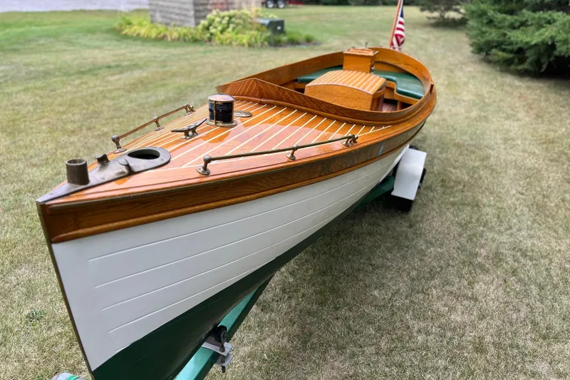 Slide: The Image of Vintage 1908 Outing launch boat on trailer, showcasing wooden craftsmanship and classic design. - 3