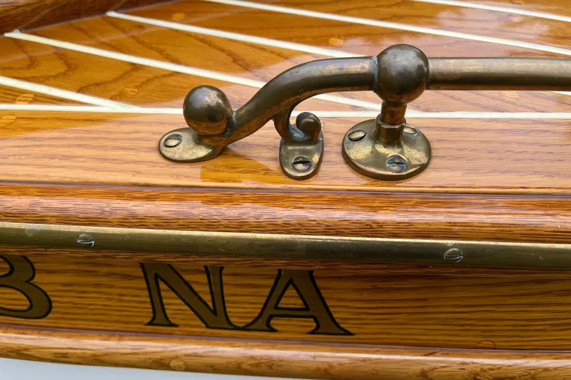 Slide: The Image of Vintage 1908 Outing launch boat with brass fittings and wooden detailing. - 7