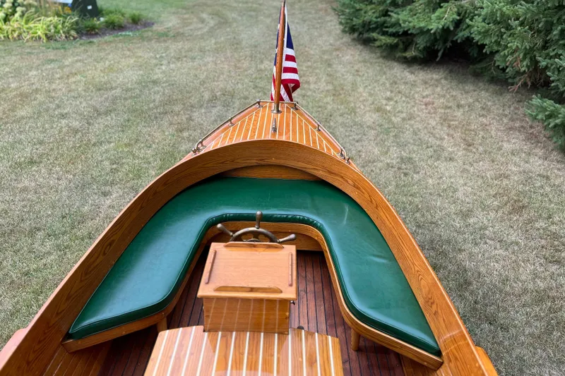 Slide: The Image of Vintage 1908 Outing launch boat with wooden deck and green seating. - 8