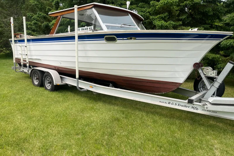 The Image of 1979 Skiff Craft 24 Flybridge boat on trailer, parked on grass. - 1