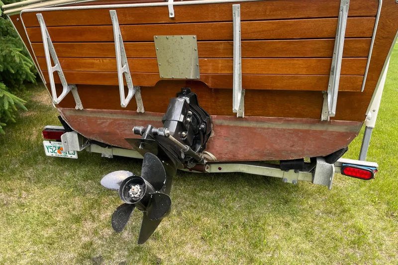 Slide: The Image of 1979 Skiff Craft 24 Flybridge boat stern with propeller on trailer. - 12