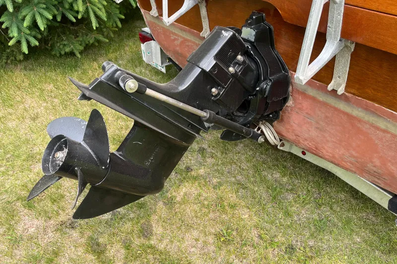 Slide: The Image of 1979 Skiff Craft 24 Flybridge boat propeller and stern drive on grass. - 14