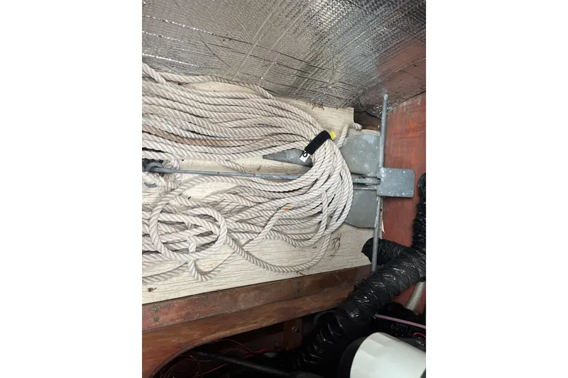 Slide: The Image of Coiled rope and equipment inside a 1979 Skiff Craft 24 Flybridge boat. - 18