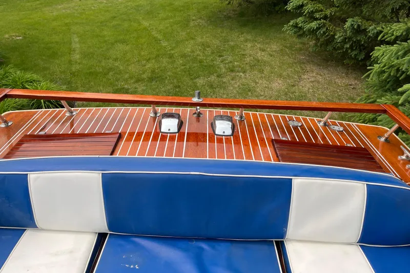 Slide: The Image of 1979 Skiff Craft 24 Flybridge with polished wood deck and blue-white seating. - 23