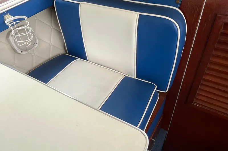 Slide: The Image of 1979 Skiff Craft 24 Flybridge interior with blue and white seating. - 27