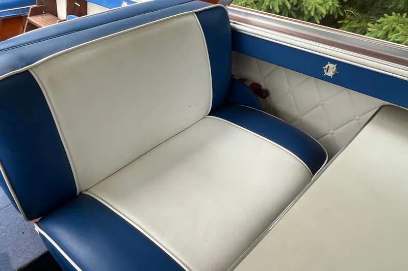 Slide: The Image of 1979 Skiff Craft 24 Flybridge interior with blue and white seating. - 28