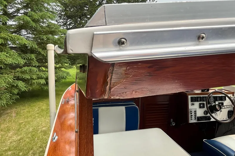 Slide: The Image of 1979 Skiff Craft 24 Flybridge interior with wood detailing and steering wheel. - 33