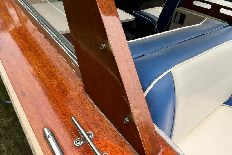 Slide: The Image of 1979 Skiff Craft 24 Flybridge interior with polished wood and blue-white seating. - 34