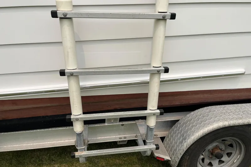 Slide: The Image of Ladder attached to 1979 Skiff Craft 24 Flybridge boat on trailer. - 36