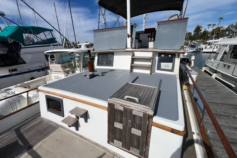 Slide: The Image of 1978 Marine Trader 40 yacht docked at marina, featuring spacious deck and classic design. - 10