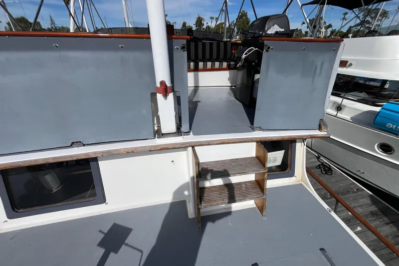 Slide: The Image of 1978 Marine Trader 40 boat deck with steps and railing, docked at marina. - 11