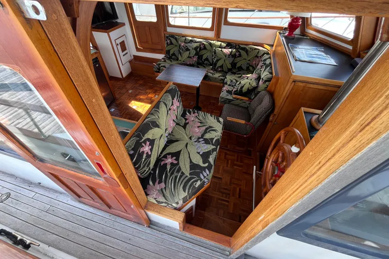 Slide: The Image of 1978 Marine Trader 40 interior with floral upholstery and wooden accents. - 15