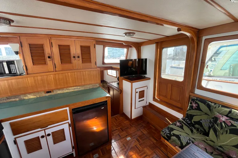 Slide: The Image of Interior of 1978 Marine Trader 40 yacht with wood paneling, kitchenette, and seating area. - 17