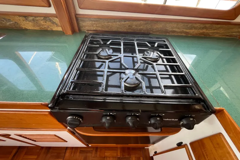 Slide: The Image of 1978 Marine Trader 40 kitchen with black stove and green countertop. - 21