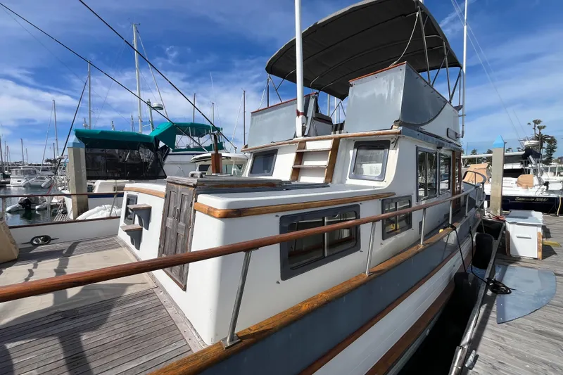 Slide: The Image of 1978 Marine Trader 40 yacht docked at marina under clear blue sky. - 3