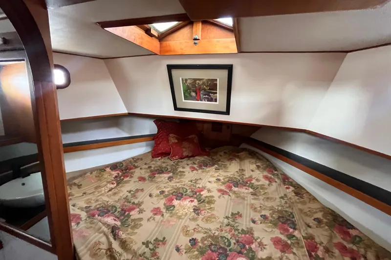 Slide: The Image of Cozy cabin interior of 1978 Marine Trader 40 with floral bedding and framed artwork. - 30
