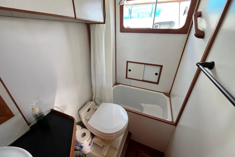 Slide: The Image of Bathroom interior of 1978 Marine Trader 40 yacht, featuring toilet and bathtub. - 35