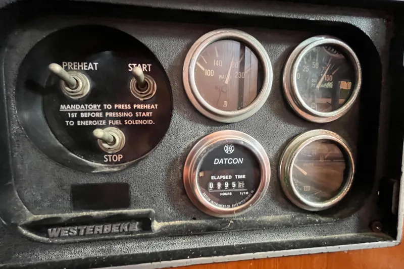Slide: The Image of Control panel of a 1978 Marine Trader 40 with gauges and switches. - 36