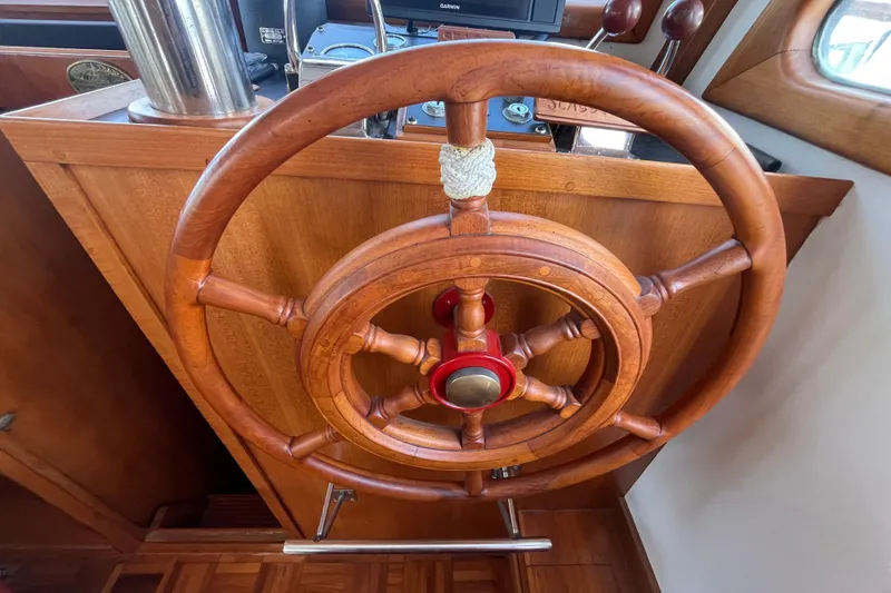 Slide: The Image of Wooden helm of a 1978 Marine Trader 40 boat, showcasing classic nautical design. - 37