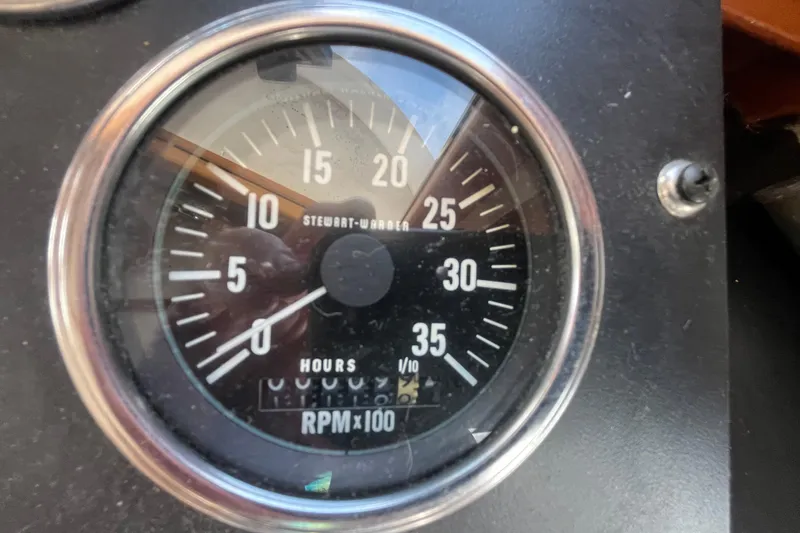 Slide: The Image of Tachometer gauge on 1978 Marine Trader 40, displaying RPM and engine hours. - 38