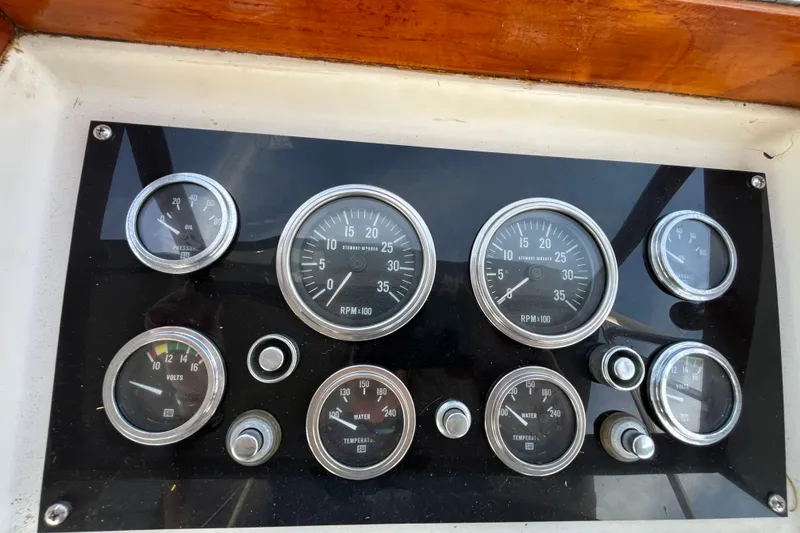 Slide: The Image of Dashboard of a 1978 Marine Trader 40 boat with various gauges and dials. - 44