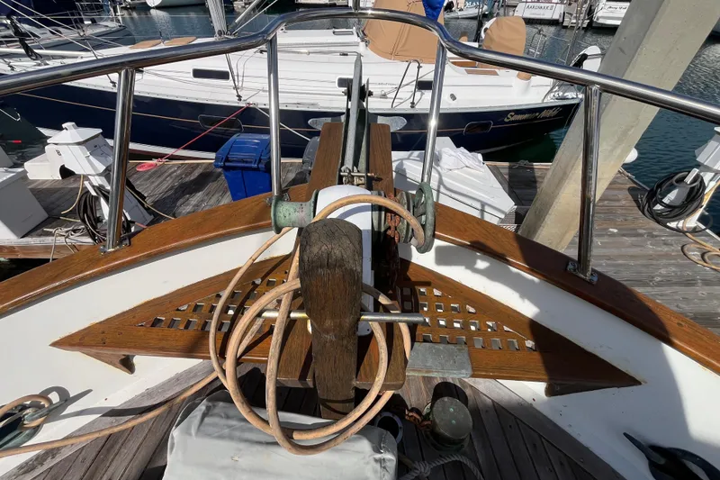 Slide: The Image of 1978 Marine Trader 40 yacht deck with wooden details and docked boats. - 6