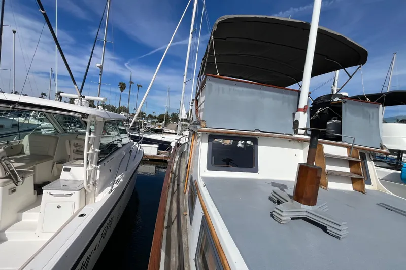 Slide: The Image of 1978 Marine Trader 40 yacht docked at marina under clear blue sky. - 9