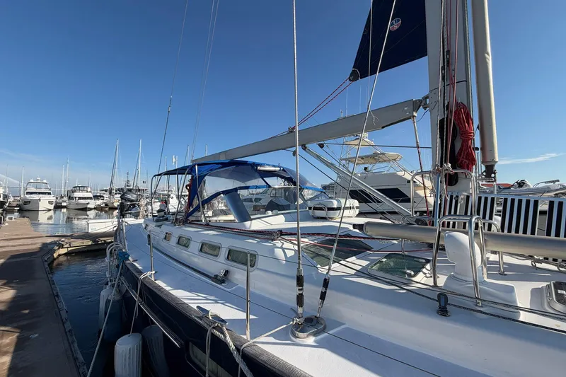 Slide: The Image of Sailing yacht Beneteau 57, 2004 model, docked at marina under clear blue sky. - 10