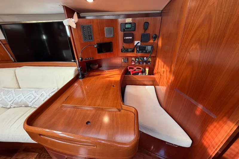 Slide: The Image of Luxurious 2004 Beneteau 57 yacht interior with navigation station and plush seating. - 46