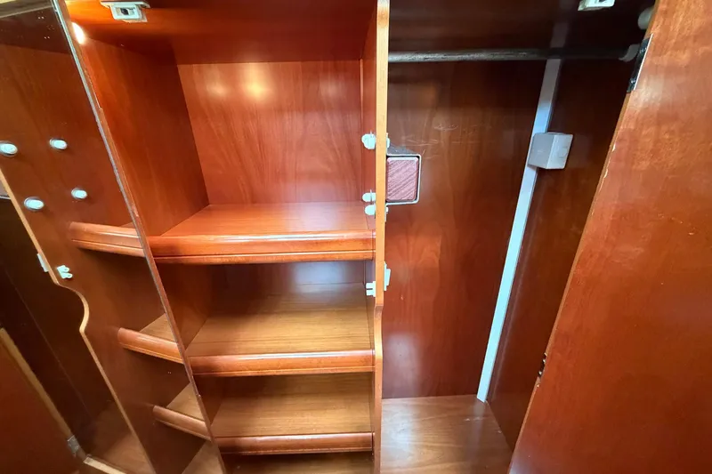 Slide: The Image of Wooden interior shelving and closet space on a 2004 Beneteau 57 yacht. - 59