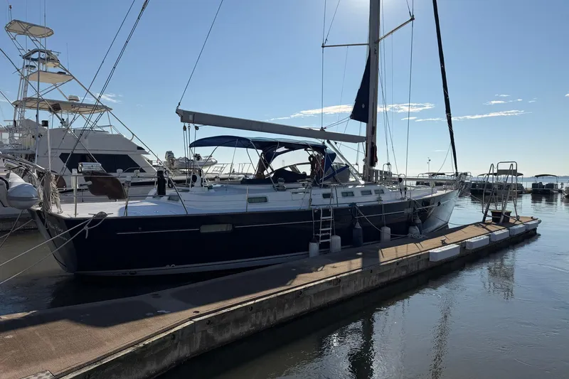 Slide: The Image of Sailing yacht Beneteau 57, 2004 model, docked at marina under clear blue sky. - 6