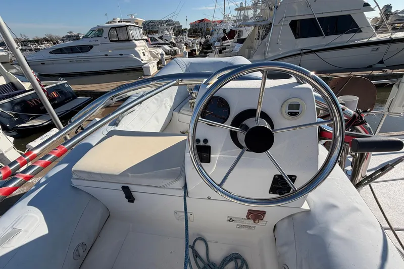 Slide: The Image of Steering wheel of a 2004 Beneteau 57 yacht docked at a marina. - 91