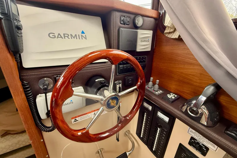 Slide: The Image of 2017 Ranger Tugs R-25 helm with Garmin navigation and wooden steering wheel. - 11