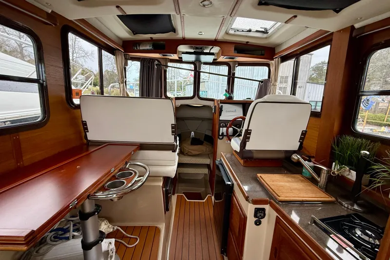 Slide: The Image of Interior of 2017 Ranger Tugs R-25 boat with wood accents and modern amenities. - 4