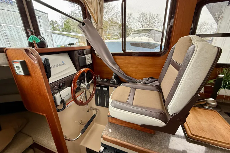 Slide: The Image of Interior of 2017 Ranger Tugs R-25 boat with steering wheel and navigation equipment. - 8